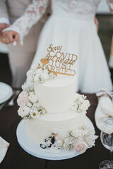 Newlyweds cutting wedding cake. The sweetest tradition of a wedding.