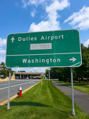 Dulles airport and Washington information road sign next to the road.