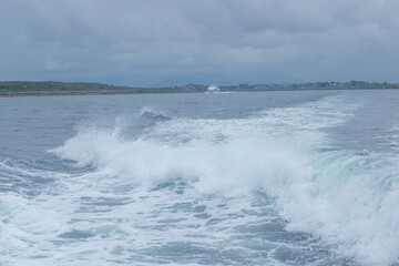 sea whirpool waves leftafter fast goig ship .