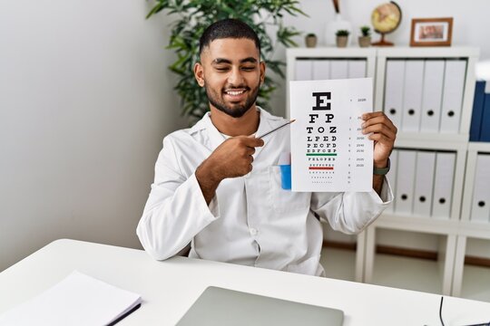 Young arab man holding sneller test at clinic