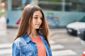 Adorable girl smiling confident looking to the side at street