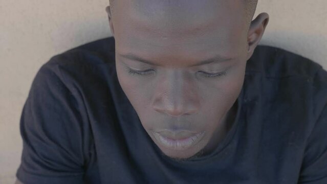 portrait of young serious afrcan man looking serious at camera