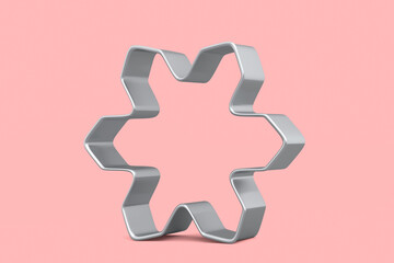 Metal cookie cutters for homemade Christmas biscuit on a pink background.
