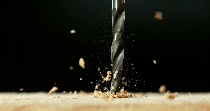 Super slow motion of detail of a drill bit drilling into wood. Filmed on high speed cinema camera, 1000 fps.