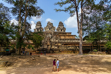 Cambodia. Siem Reap. The archaeological park of Angkor. A couple of tourists in front of Ta Keo Hindu temple