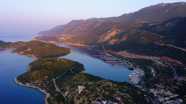 Sea bay surrounded by mountains. Resort town cityscape and nature landscape. Aerial panoramic view from drone.