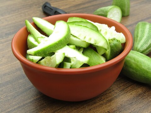 pointed gourd sliced in a bowl on wooden background 