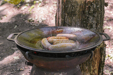 sausages fried in a cauldron