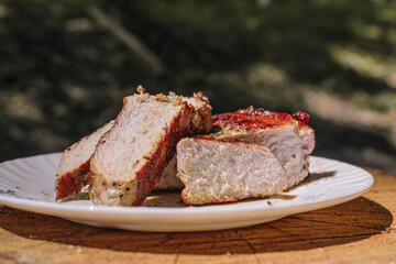 Delicious grilled pork on the plate with fork and knife