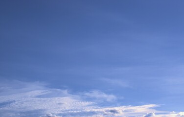 Clear, peaceful blue sky with fluffy white clouds floating slowly Background Banner Screensaver on the monitor.