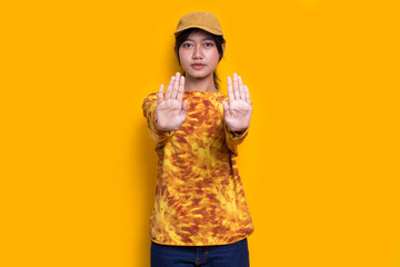 young woman with open hand doing stop sign with serious expression defense gesture isolated on...