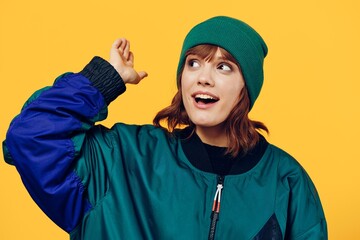 a sweet, happy woman in a stylish 90s jacket stands on a bright background and smiles happily looking away