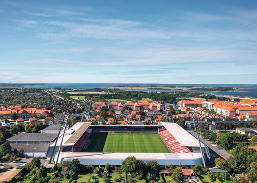 Aerial summer view of Aalborg stadion (also known as Portland park) with a panoramic cityscape. Home stadium for AaB football club. Aalborg, Denmark - September 2022