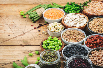Legumes, beans and sprouts. Dried, raw and fresh, top view. Lentils, mung beans, chickpeas, soybeans, edamame, peas, Healthy diet food, vegan protein, micronutrients and fiber sources