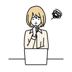 デスクで座ってPCを開いて困っているブラウスの女性