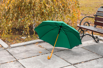 Bright umbrella near bench in park