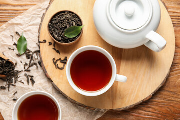 Fototapeta na wymiar Composition with hot black tea on wooden background