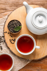 Composition with hot black tea on wooden background