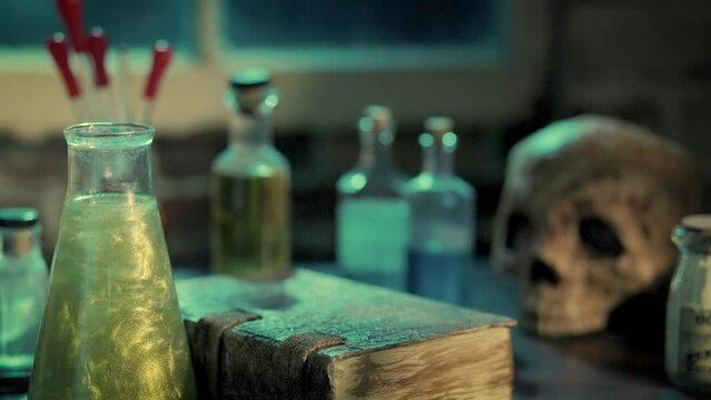 flask of magic potion on table with spell book