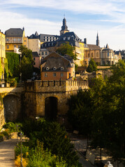 Scenic view of Ville Haute district in historic center of Luxembourg City overlooking Baroque belfry of Saint Michael Church towering over residential buildings..