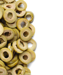 Many slices of tasty green olives on white background, closeup