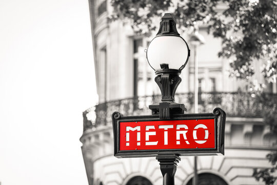 Illustration picture shows a sign with the subway logo (red symbol) in front of a parisian metro (metropolitain) station during a summer day in Paris, France.