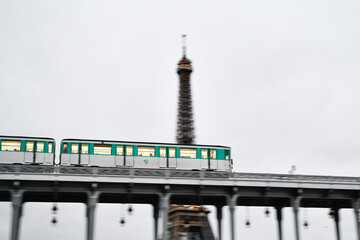 The parisian subway (metro, metropolitain) passes over a bridge with the Eiffel Tower (