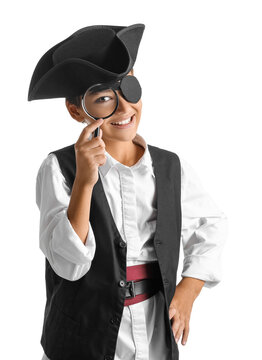 Little boy dressed as pirate with magnifier on white background
