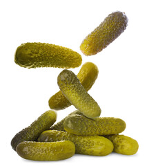 Tasty pickled cucumbers falling into pile on white background