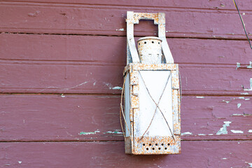 Installation set of antique objects on the wall of a wooden house