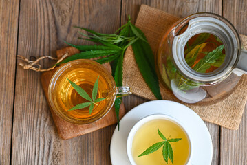 Cannabis tea herbal on tea cup with cannabis leaf marijuana leaves herb, Health tea with hemp leaf plant THC CBD herbs food and medical