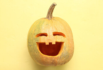 Jack-O-Lantern pumpkin on yellow background