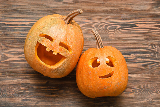 Carved Halloween pumpkins on wooden background