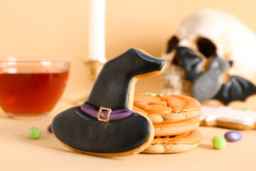 Halloween cookies and candies on beige background, closeup
