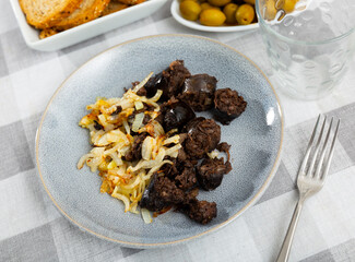 Delicious Catalan blood sausage with rice garnished with baked onions. Popular Spanish tapas..