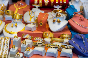 Assortment of gold jewelry displayed for sale on shelves in jewelry store at Turkey