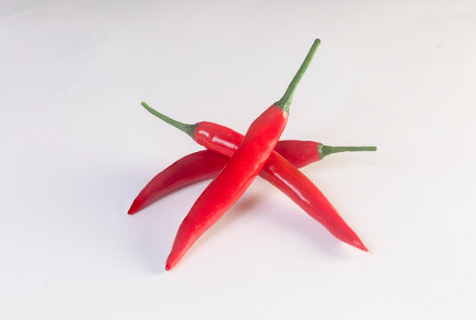 Chili pepper isolated. Chilli top view on white background. Three red hot chili peppers top.