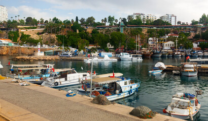 Fototapeta na wymiar Old town harbor and port of Turkish city Antalya with variety of boats.