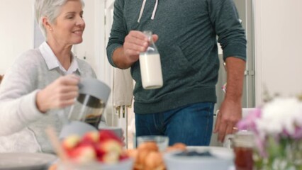 Breakfast, coffee and couple with a senior man and woman eating a meal and drinking at a table together in their house. Food, retirement and morning with an elderly male and female pensioner at home - Powered by Adobe
