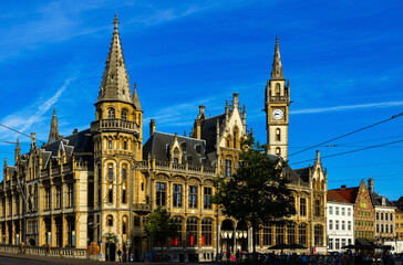 Fototapeta na wymiar Ghent, Old Post Office on Korenmarkt Square under deep blue sky. Flemish Region of Belgium.
