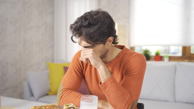 Disabled young man crying at home.
Disabled young man in wheelchair eating and crying at home.
