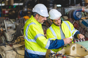 professional technician engineer with safety helmet hard hat working in industrial manufacturing factory, men at work to checking equipment of machinery production technology or construction operating