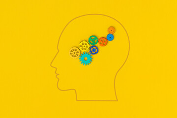 Human head with gears on yellow background
