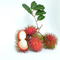 A bunch of ripe rambutan fruits with leaves isolated on white background.	
