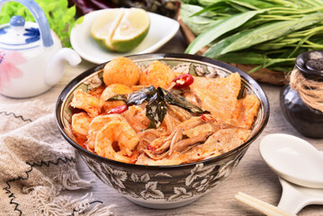 Singapore laksa - spicy noodle soup with noodles, prawns,  chicken, tofu, fishball served in spicy curry coconut milk 