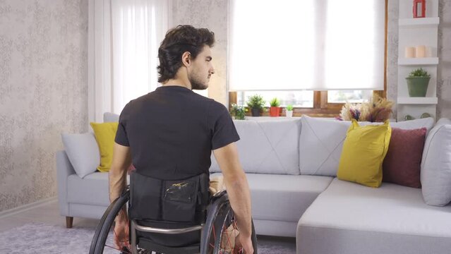 Depressed sad young disabled person in wheelchair.
Disabled teenager in wheelchair is thoughtful and depressed at home.

