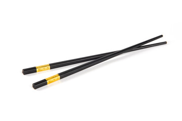 black chopsticks with golden ornamentation isolated on white background