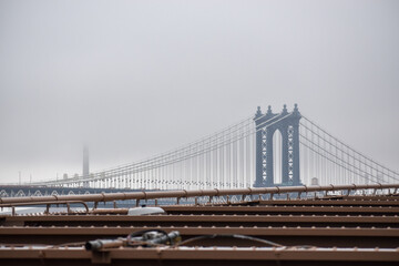 Manhattan Bridge is seen in a distance on a foggy day, March 17, 2022 in New York City.