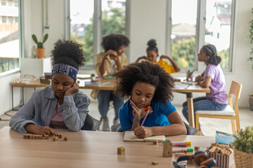 Young African girls taking class with other friends.