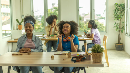 Young African girls are excited and happy by raising their hands to express their feeling in class. Hand celebration